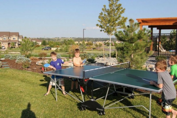 kids playing ping pong at lawn game social event at Inspiration community near Parker Co