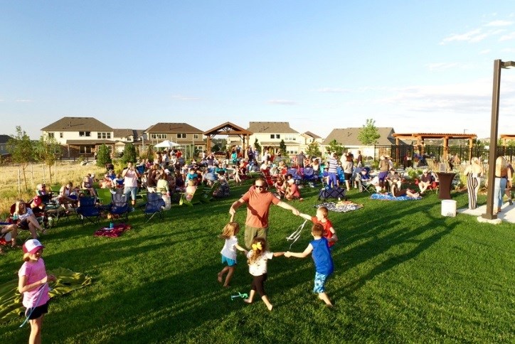 Family dances on event lawn at Spark event in Inspiration
