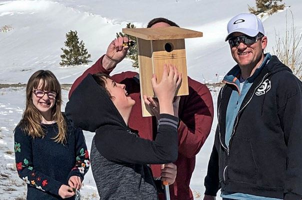 Inspiration residents installing a birdhouse in Inspiration community near Parker Colorado