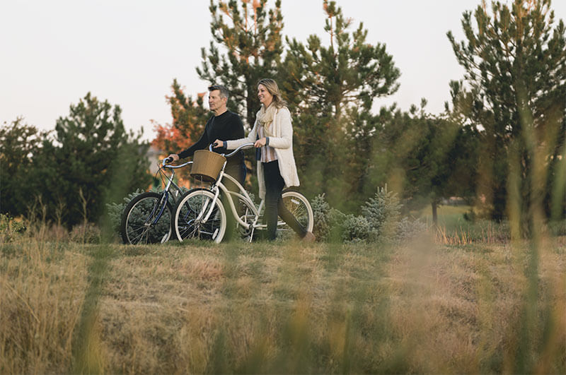 Residents Biking in Hilltop at Inspiration 55+ Community in Parker Colorado